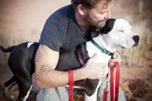 man with white dog