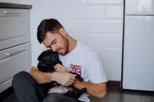 man hugging dog