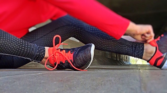 person tying running shoes